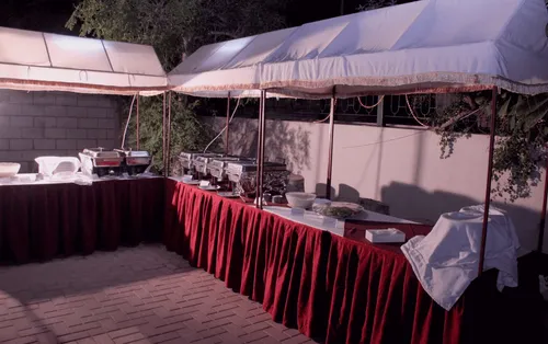 A photo of an outdoor buffet set up on nice, draped tables