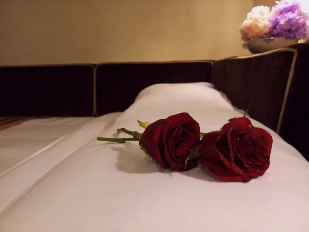 Flowers on a hotel bed