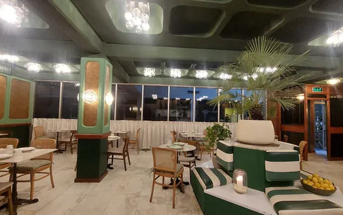 A photo of the Nafoora Coffee Shop, displaying a fountain in the center of a large room